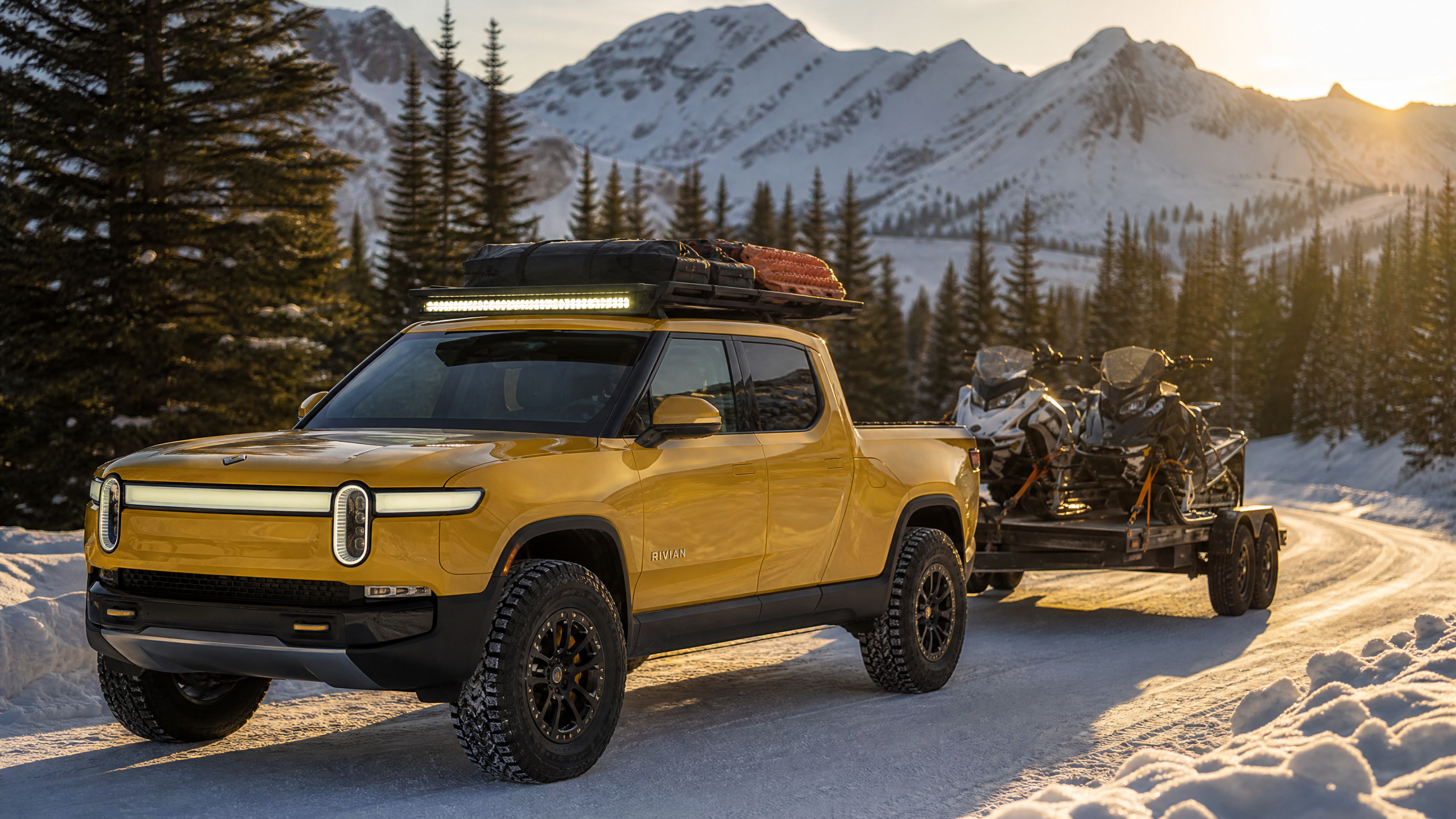Rivian R1T Towing Snowmobiles - Compass Yellow